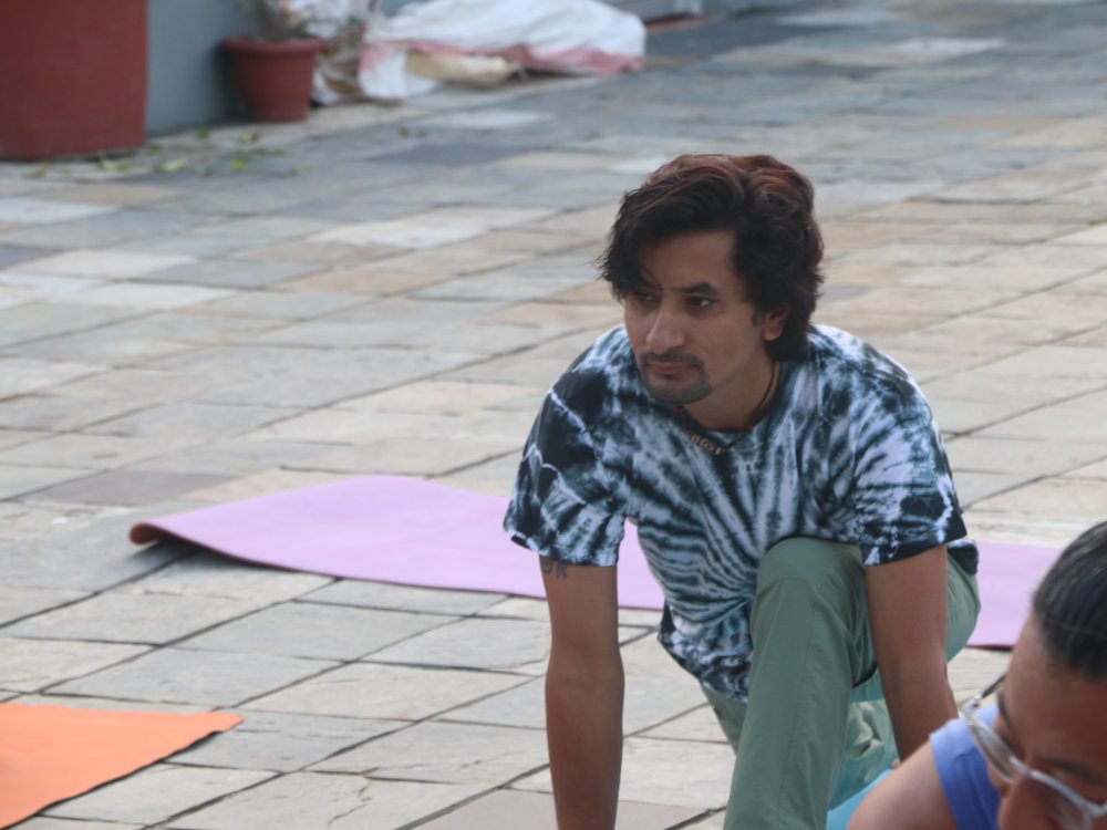 Master Akash teaching a yoga class with calm focused presence.